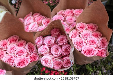 Pink roses bouquets in paper in a flower shop