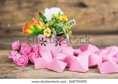 pink roses and paper hearts on a wooden background. space for text Happy Valentine's Day card