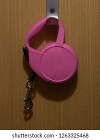 Pink Roulette Dog Leash Hanging On The Wall