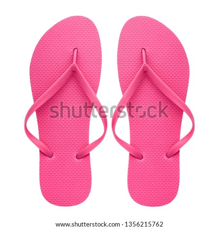 Pink rubber flip-flops isolated over white background, pair of thongs, shot above.