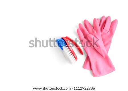 Pink rubber gloves and red brush isolated on white background.