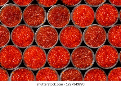 Pink salmon caviar and chum salmon caviar in plastic containers. Seafood, delicacies, healthy nutrition. Top view. Pattern of caviar. 