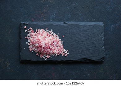 
Pink Salt From The Himalayas On An Black Stone Plate On Dark Background. Top View, Flat Lay.