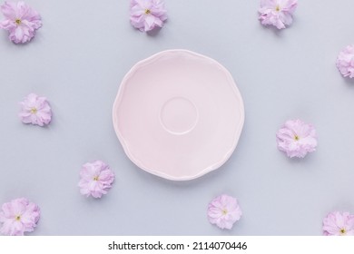 Pink saucer or dessert plate and fresh spring cherry blossom flowers
