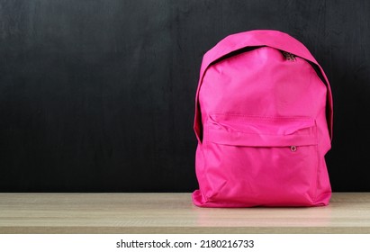 Pink School Backpack, A Girl's Sports Bag On The Desk On A Black Background. Copy Space.