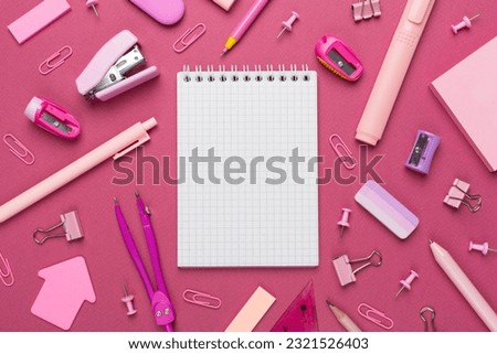 Pink school stationery with notebook on color backgroung, top view