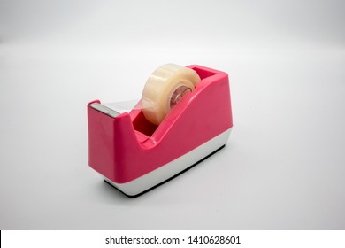 Pink Sellotape scotch tape dispenser isolated on white background