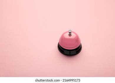 Pink Service Bell On Pink Background. Top View