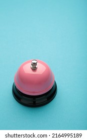 Pink Service Bell On Blue Background. Top View