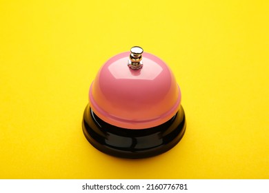 Pink Service Bell On Yellow Background. Top View