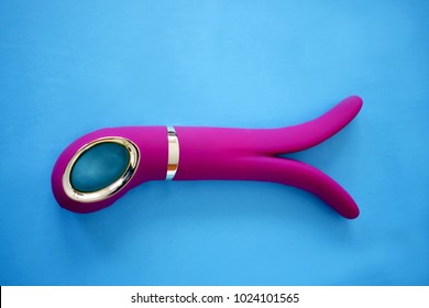 Pink sex toy on a blue background