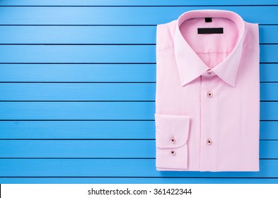 Pink Shirt On Blue Wooden Background