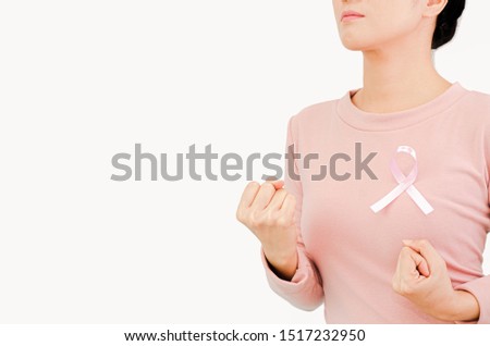 Pink shirt with a ribbon attached to the chest.Do not focus on objects.World Breast Cancer Day Concept.