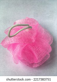 A Pink Shower Puff Used For Bathing