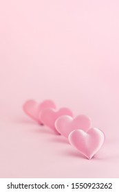 Pink silk heart on a pink background is standing in line. - Shutterstock ID 1550923262