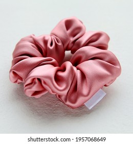 pink silk Scrunchy isolated on white background. Flat lay Hairdressing tool of Colorful Elastic Hair Band, Bobble Scrunchie Hairband