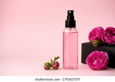 Pink Skin Tonic In A Plastic Bottle With Rose Flowers On Pink Background