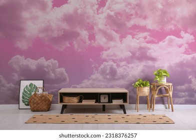 Pink sky with clouds on wallpaper in furnished room. Beautiful interior design