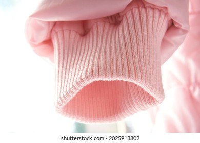 Pink Sleeve Of Jacket Or Sweater, Cuff For Sealing. Narrowing Sleeves On A Light Background, Magky Selective Selective Focus.