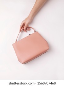 Pink Small Women Bag In Hand On A White Background From Above