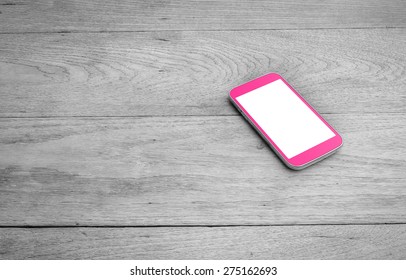 Pink Smart Phone With Blank Screen On Wooden Desk 