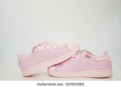 pink sneakers shoes with shoelace side view on floor soft focus with copy space