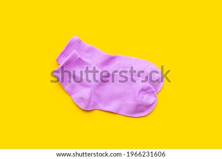 Pink socks on yellow background.