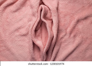 Pink soft fabric shaped as female genital organs, vulva and labia, vagina
