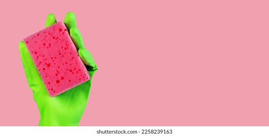 Pink sponge in hand in green glove on ad background, promotion banner design for professional cleaning service. High quality photo - Shutterstock ID 2258239163