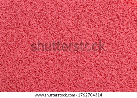Pink sponge texture. Close-up of a beautiful fleecy pink cosmetic sponge for background. Macro photograph.