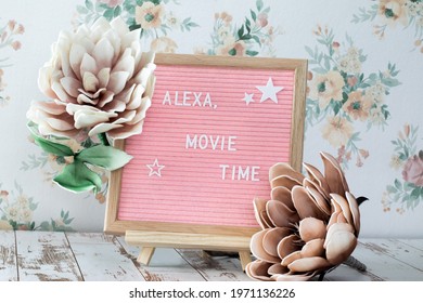 Pink Square Felt Board With Wooden Frame And A Sentence Community With Flowers And Floral Background