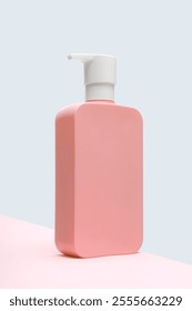 pink square shaped shampoo or soap bottle with dispenser, studio photo, pump bottle mockup