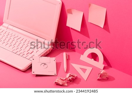 Pink stationery and pink laptop on pink background, mess on desk office barbie style. High quality photo