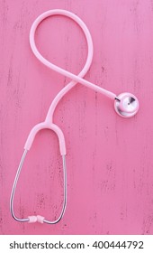 Pink Stethoscope On Pink Wood Table For Womens Health Awareness. 