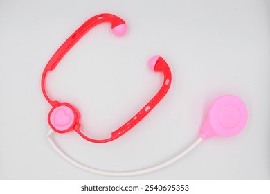 Pink stethoscope toy for kids, ideal for imaginative play, introducing children to basic medical tools in a fun and colorful way - Powered by Shutterstock