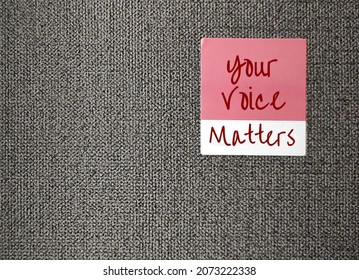 Pink sticker on wallpaper with text written YOUR VOICE MATTERS, concept of expressing one internal world out to the public space, every voices deserves to be heard