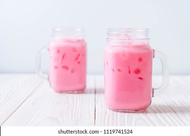 pink strawberry milkshake on wood
