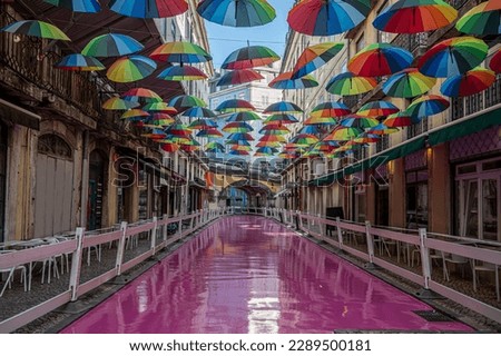 Pink Street in Lisbon, Portugal. Street with umbrellas.