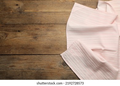 Pink Striped Kitchen Towel On Wooden Table, Top View. Space For Text