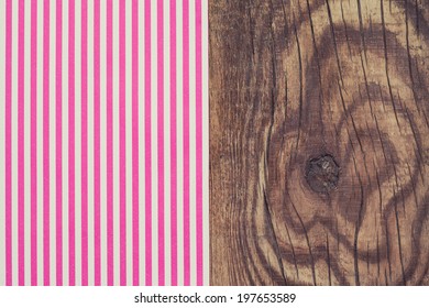 pink striped paper laying on wooden table