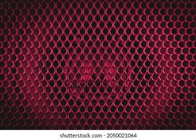 Pink Stylish Car Audio Acoustic Round Speaker With Waffle Grill Protector Cover Closeup. Modern Music Dark Background Texture. Selective Focus