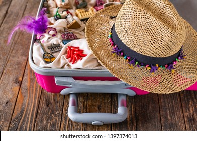 A Pink Suitcase With Figures Of Touristic Places , Souvenirs