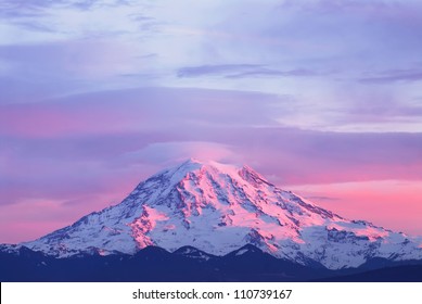 Pink sunset light on Mount Rainier in the Cascade Range, Washington State, USA