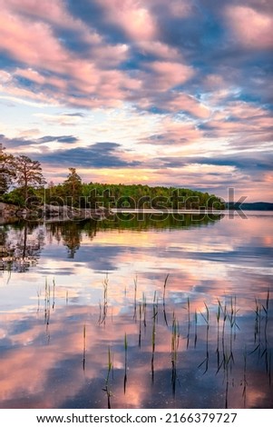 Pink sunset over lake Järnlunden Sweden.