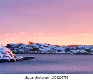 Pink sunset over rocky island at west coast of gothenburg,Sweden