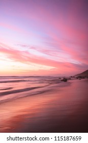 Pink Sunset Reflects On The Beach