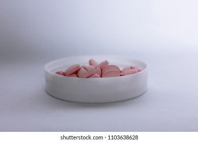 pink tablet in container