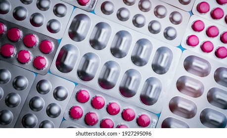 Pink Tablets In Blister Pack And Silver Aluminium Foil Pack For Capsule And Tablets Pills In Pharmaceutical Industry. Pharmaceutical Package Manufacturing. Top View Of Round Tablets Pills. Pharmacy.