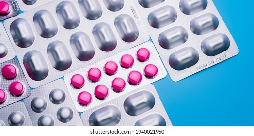 Pink Tablets In Blister Pack And Silver Aluminium Foil Pack For Capsule And Tablets Pills In Pharmaceutical Industry. Pharmaceutical Package Manufacturing. Top View Of Round Tablets Pills. Pharmacy.