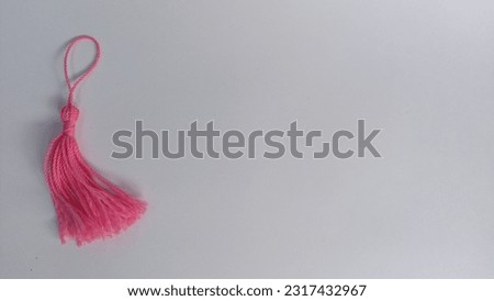 pink tassel on a white background
